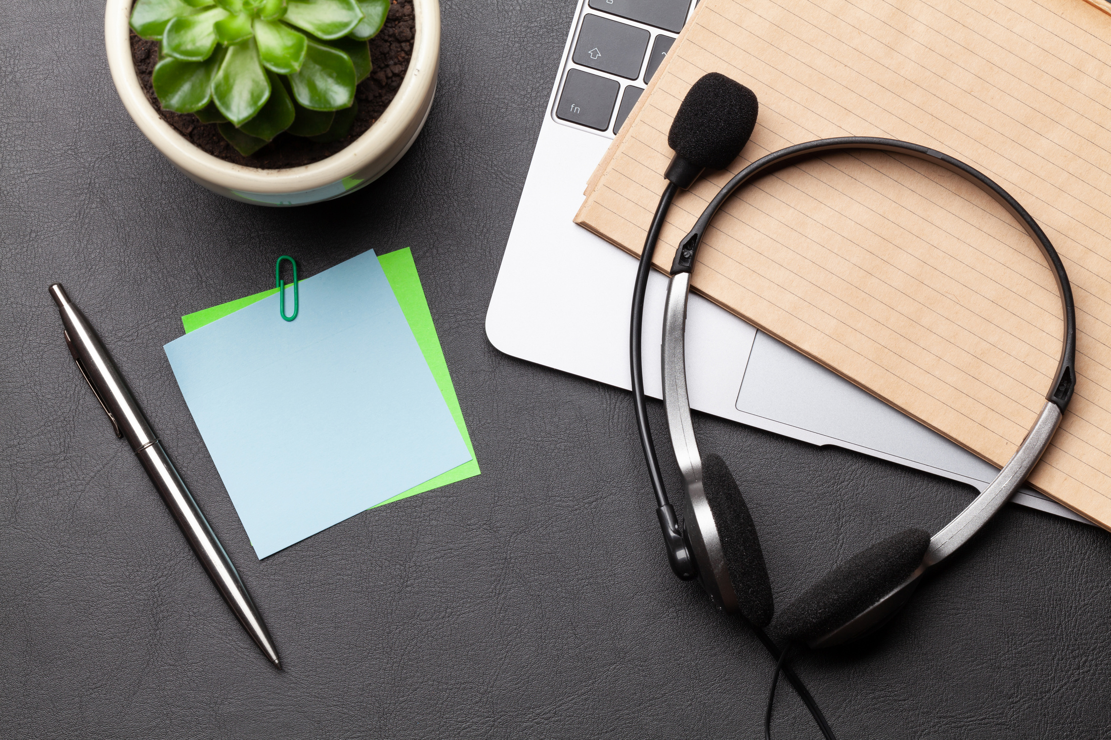 Office desk with headset and laptop